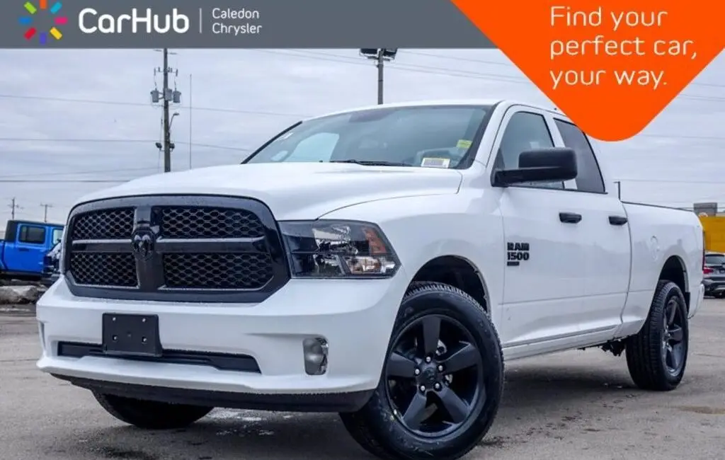 White Ram 1500 Express quad cab pickup truck with black wheels at CarHub Caledon Chrysler