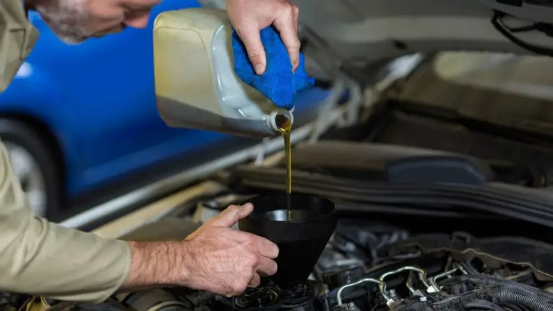 a-man-changing-its-car-transmission-fluid