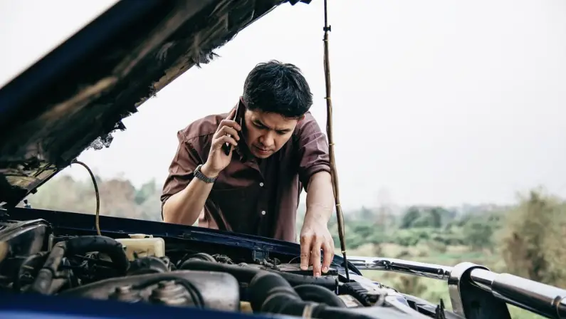 a-man-looking-at-his-car-with-transmission-problem