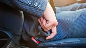 man buckling seatbelt