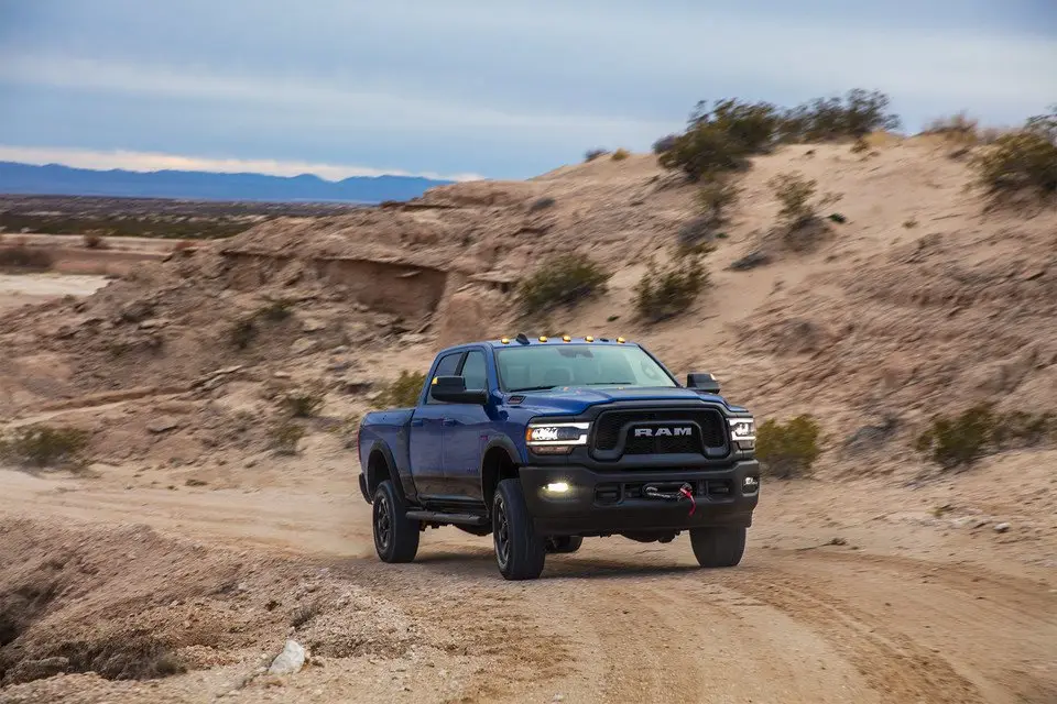 2021 Blue Ram 2500 Power Wagon pickup truck driving on desert dirt road