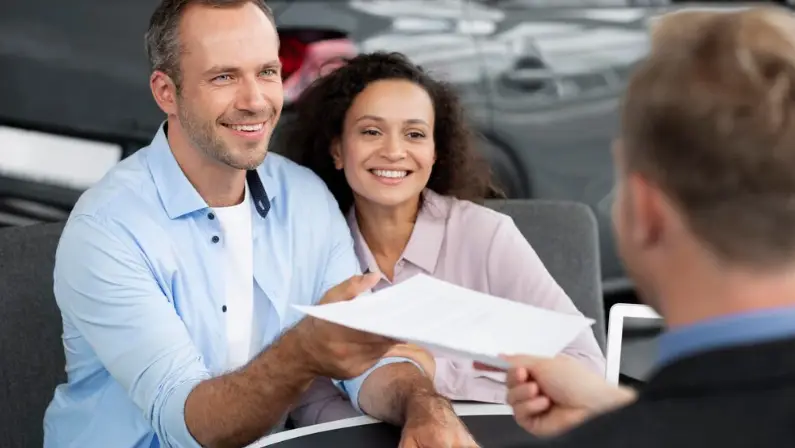 a-couple-getting-a-car-warranty-for-their-new-car
