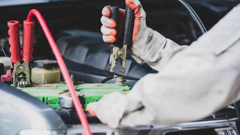 a-man-putting-a-jump-starter-in-a-car