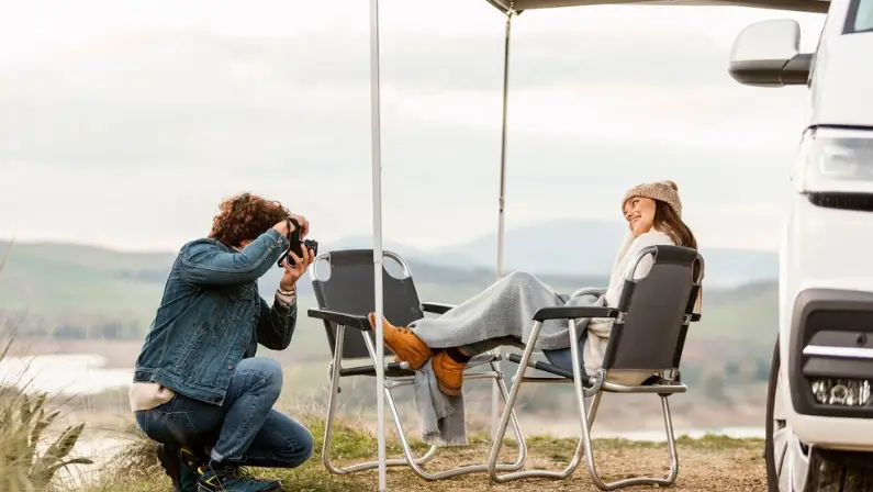 couple-relaxing-under-their-car-tent