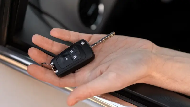 a-man-holding-a-car-key