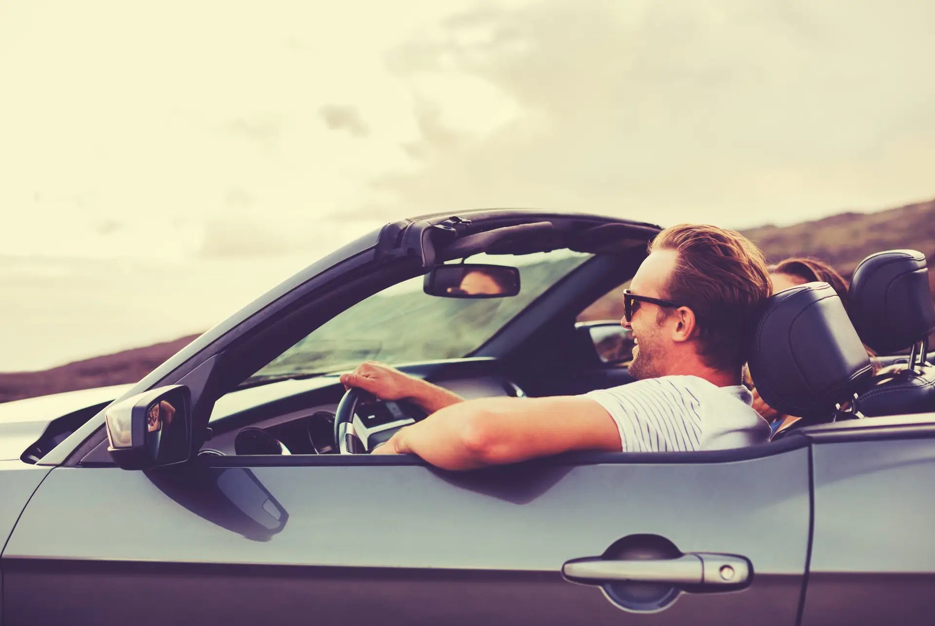 Happy Couple Driving in Convertible