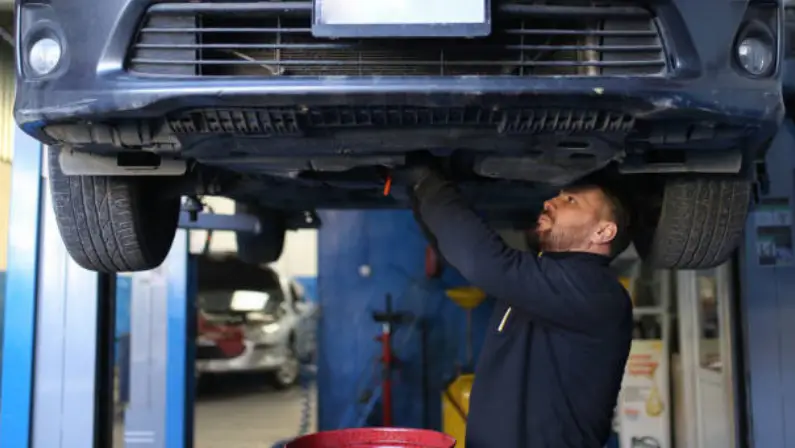a-man-changing-the-car-oil