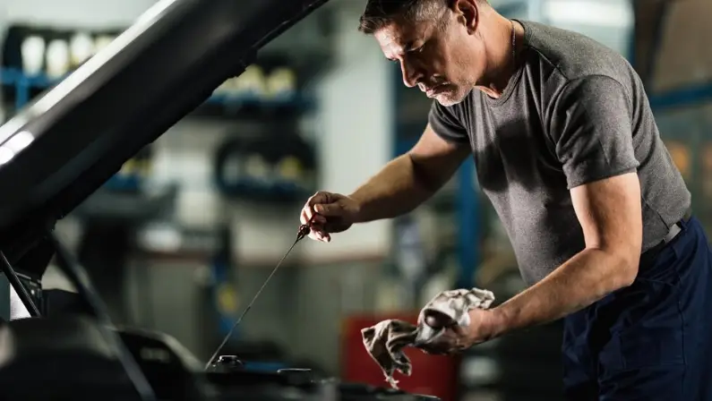 a-man-checking-his-cars-oil