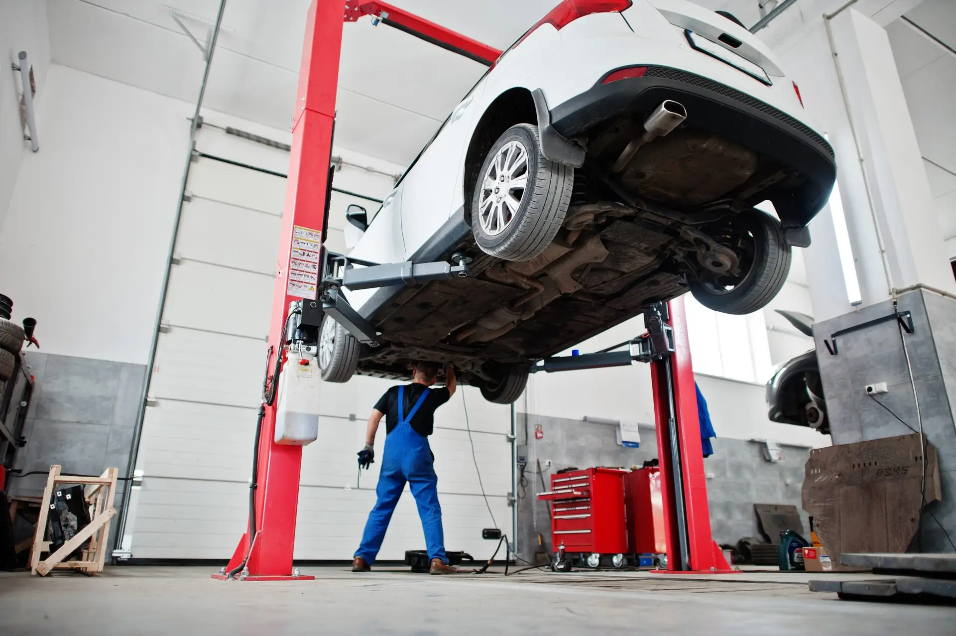 Car repair and maintenance theme. Mechanic in uniform working in
