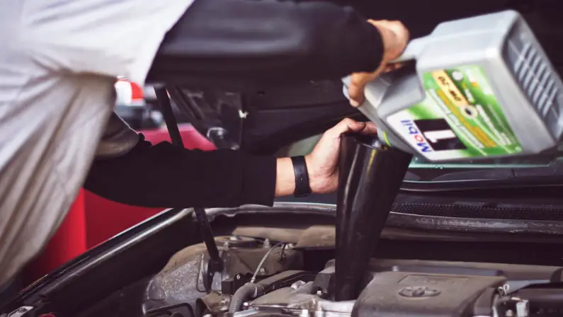 an-auto-mechanic-changing-oil-of-the-car