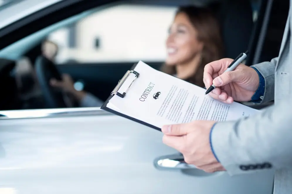 a-woman-buying-a-car-with-a-car-extended-warranty-contract