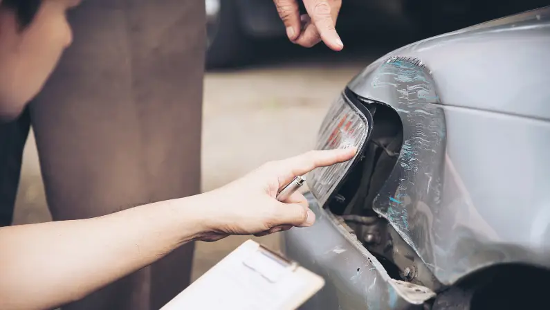 a-car-dealer-and-a-buyer-checking-the-exterior-of-the-car