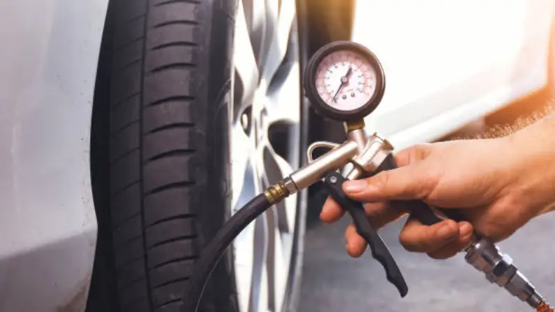 a-man-checking-the-tire-pressure