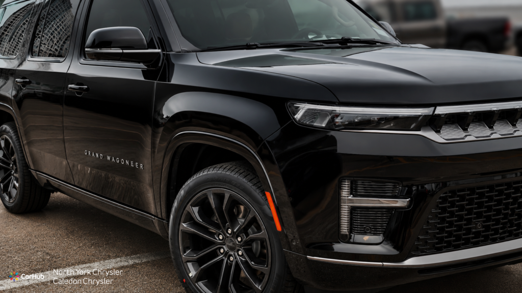 Black 2026 Jeep Grand Wagoneer Summit Reserve luxury SUV side profile showing 22-inch dark polished aluminum wheels and chrome side badging.